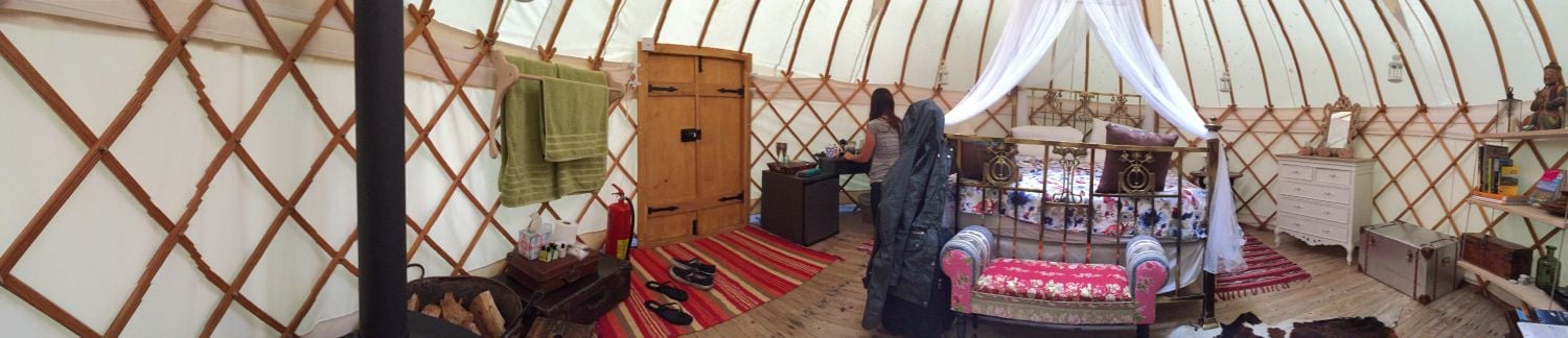 Comfortable double bed and boho décor inside the yurt near The Bridge Inn, Herefordshire.