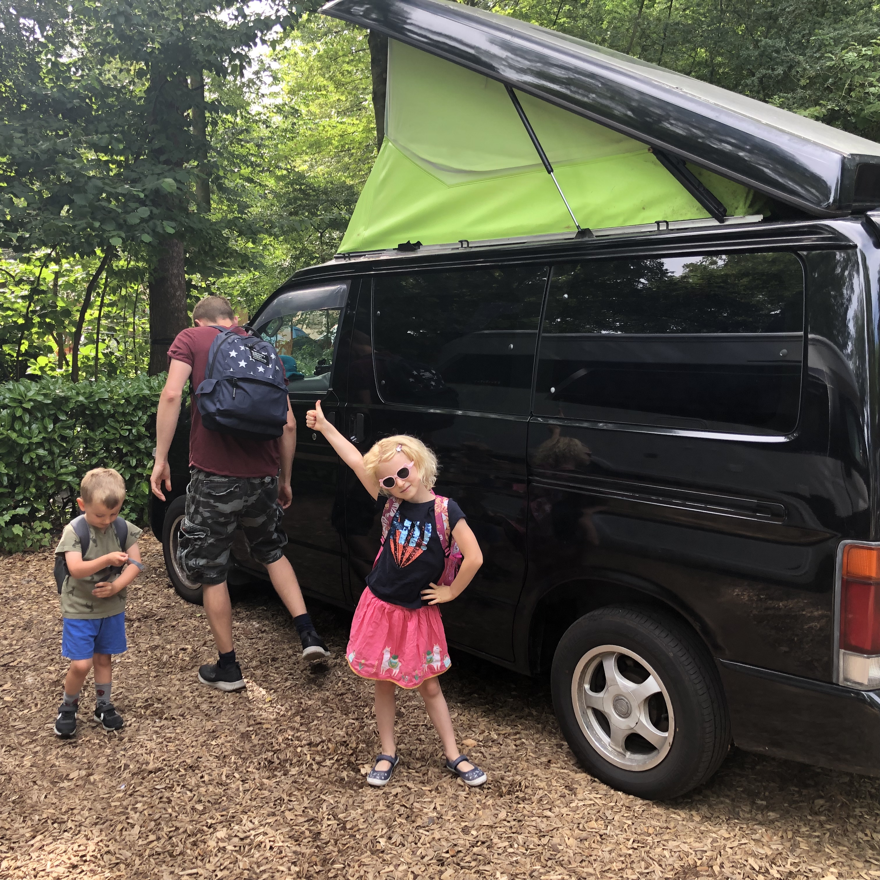 Mazda Bongo Black with Green Poptop family camping in Amsterdam
