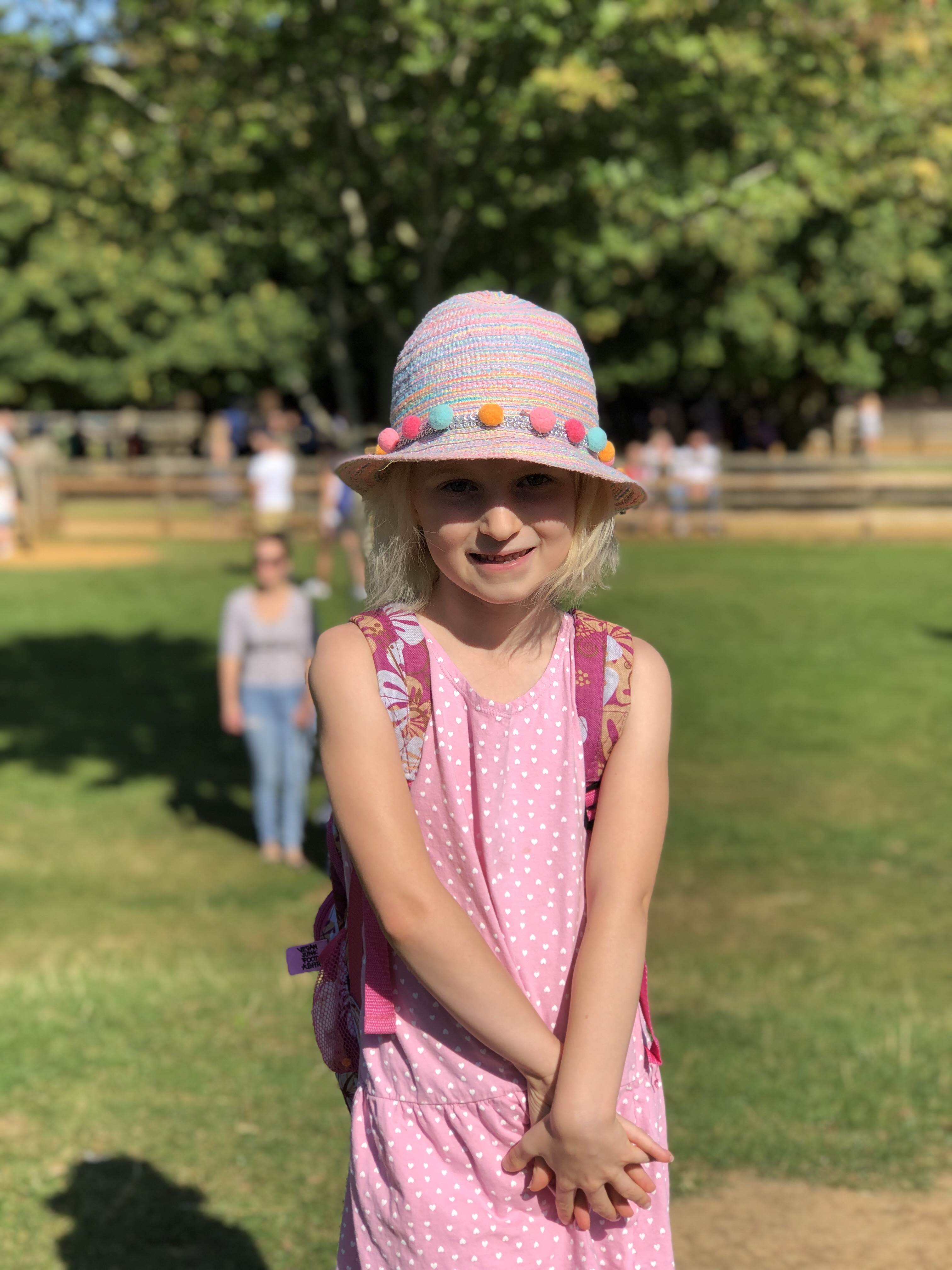 cotswold wildlife park review photo of young girl dressed in pink smiling with hands clasped together