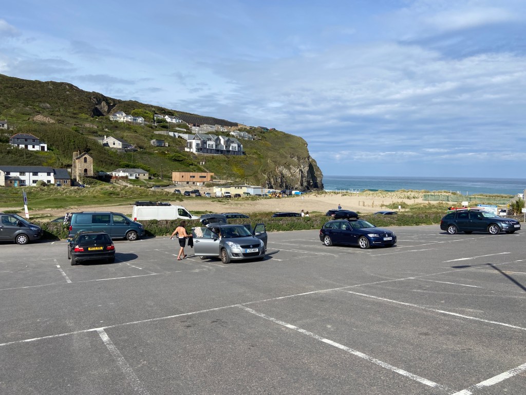 Houses on cliff and beach view from a carpark at Porthtowan beach in Cornwall