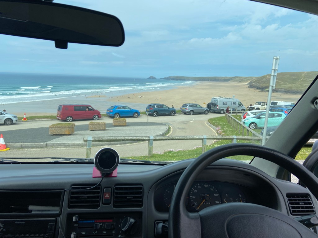 View of Perranporth beach in Cornwall from inside our campervan after parking nearby