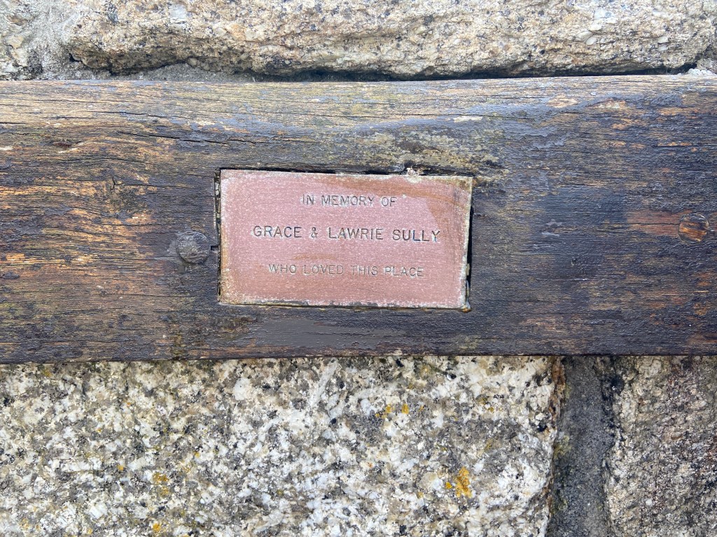 Memory bench with words In memory of grace and lawrie sully who loved this place Perranporth beach in Cornwall