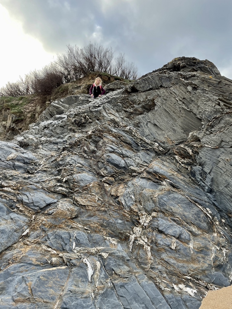 kid climbing rocks mother iveys bay cornwall