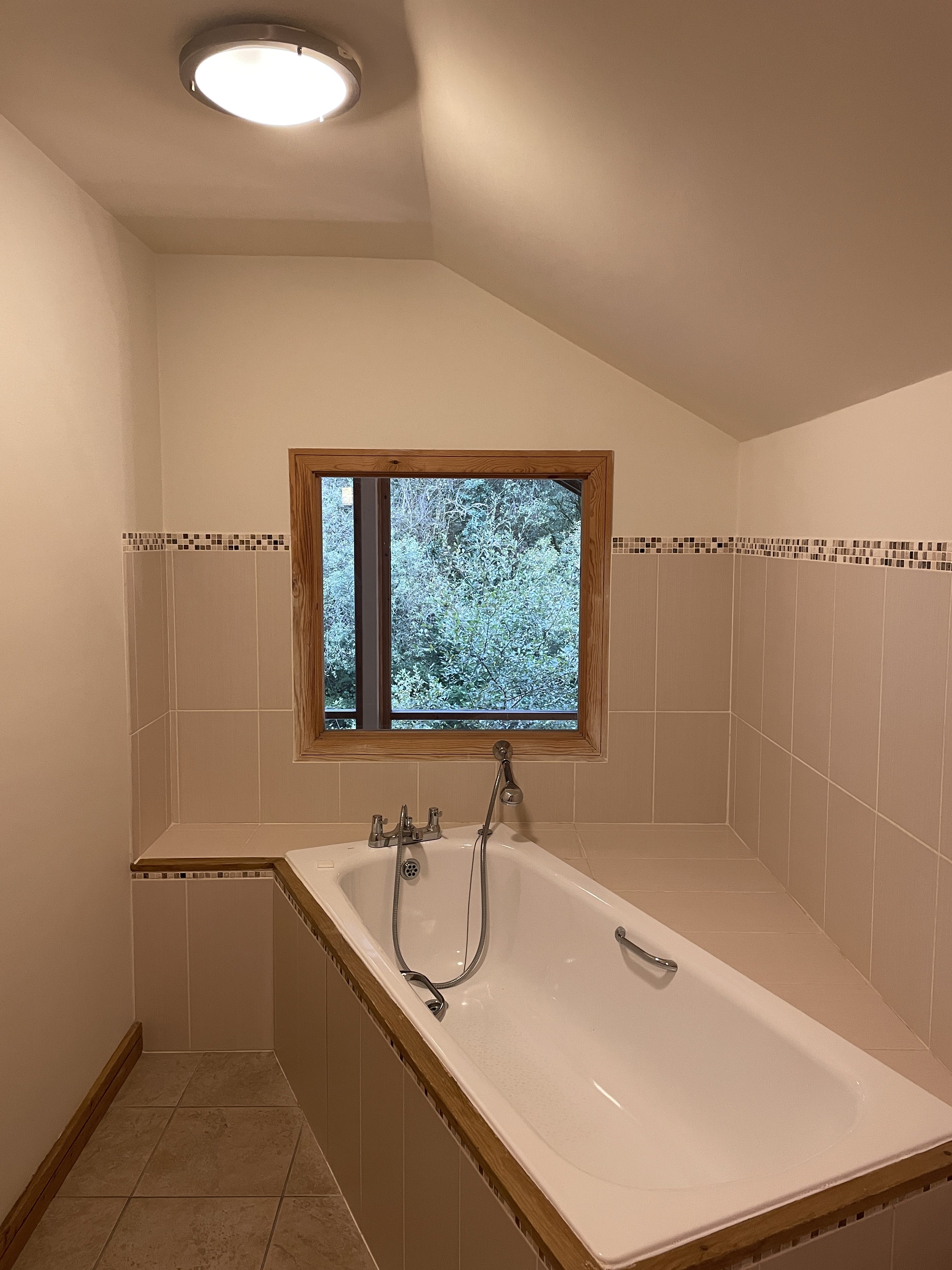 bath with tree view at deerpark forest holidays woodland lodge in cornwall