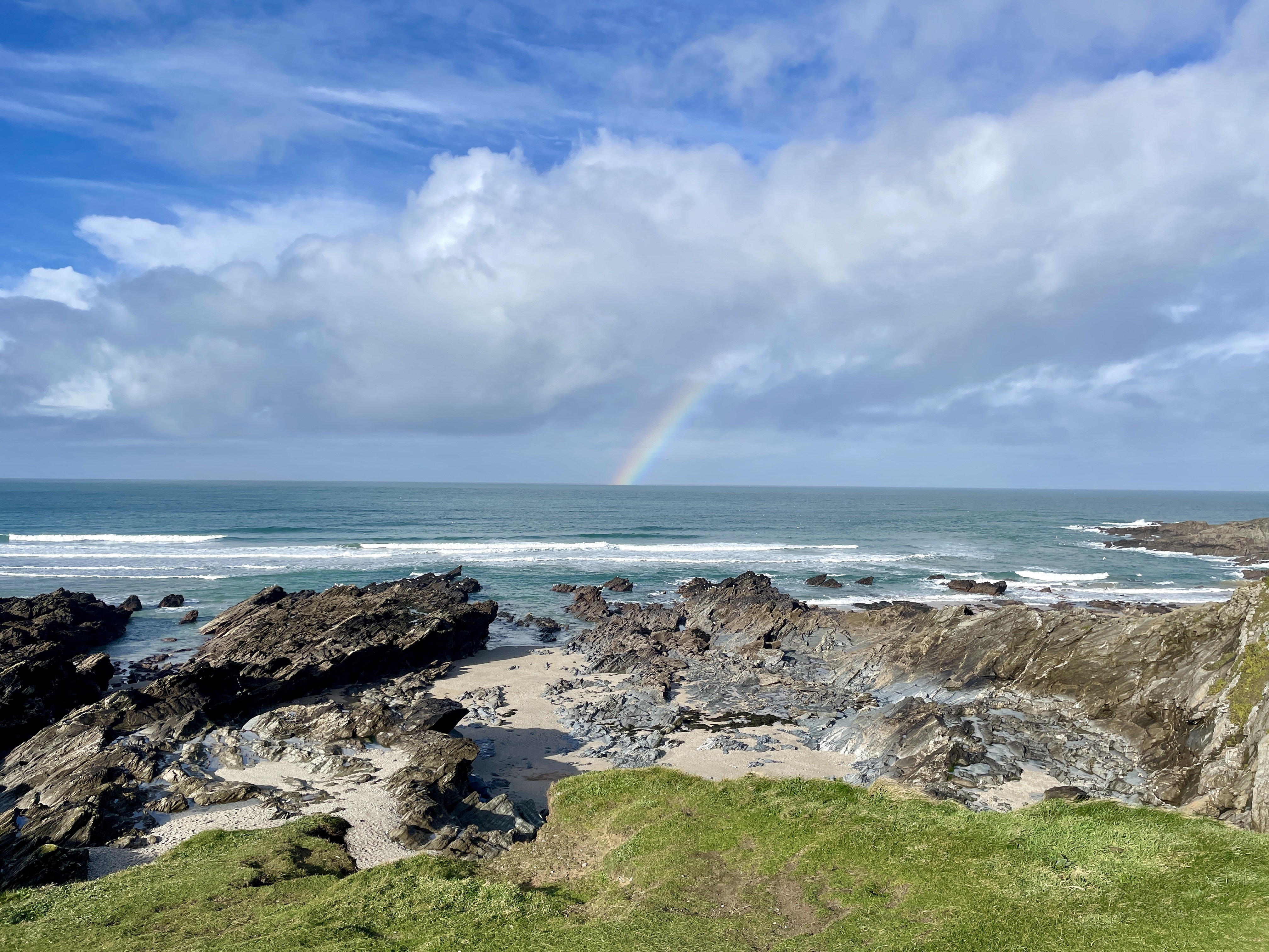 A rainbow over the sea near the rocky area between Little Fistral and Fistral Beach in Newquay