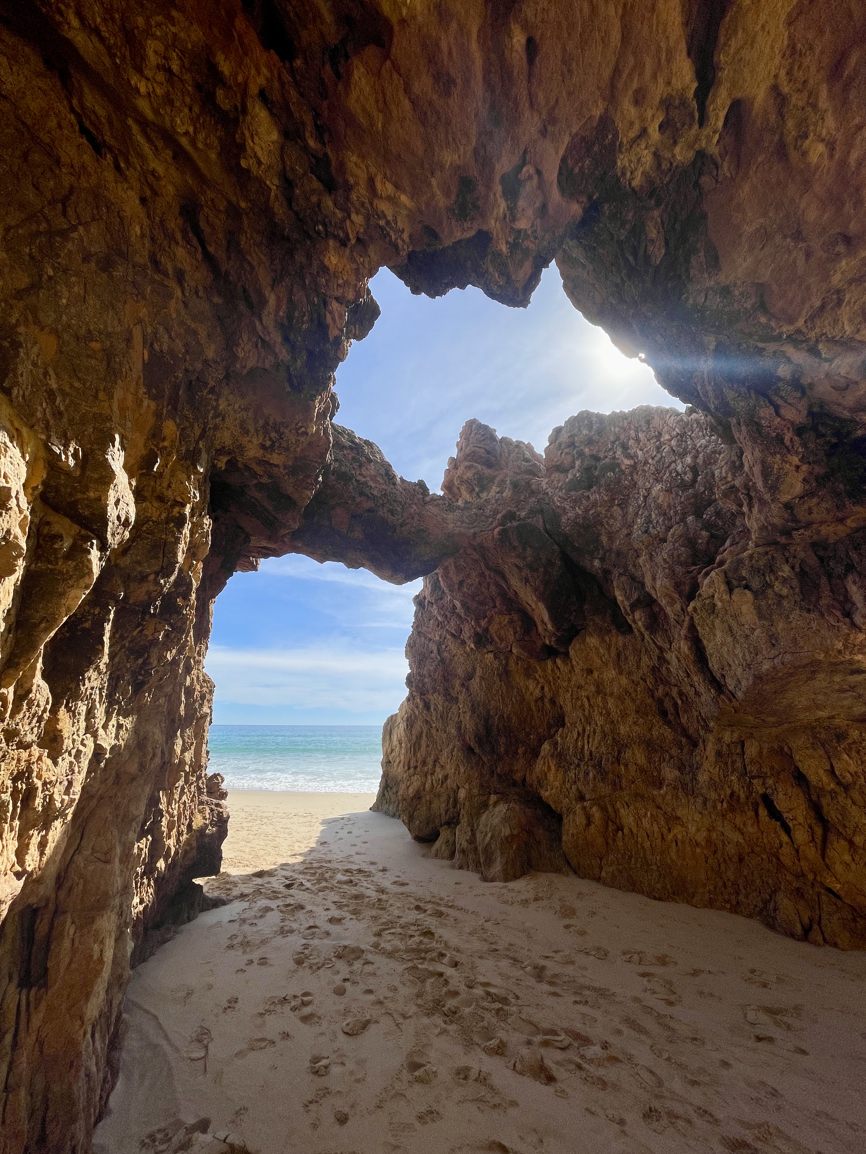 A stunning view of the sea framed by rugged cliffs at Praia da Andorinha.