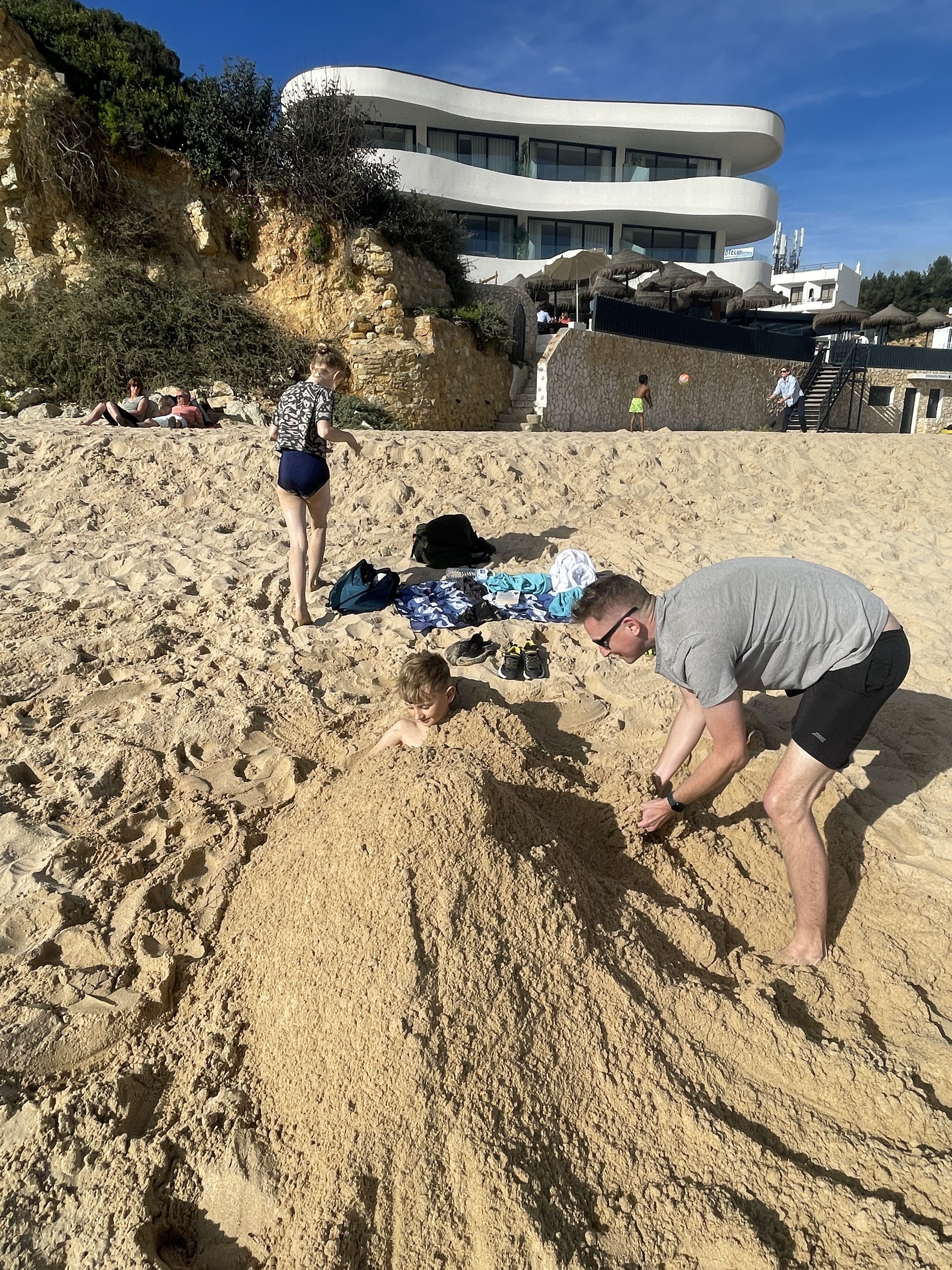 Playing in the golden sands at Salema Beach