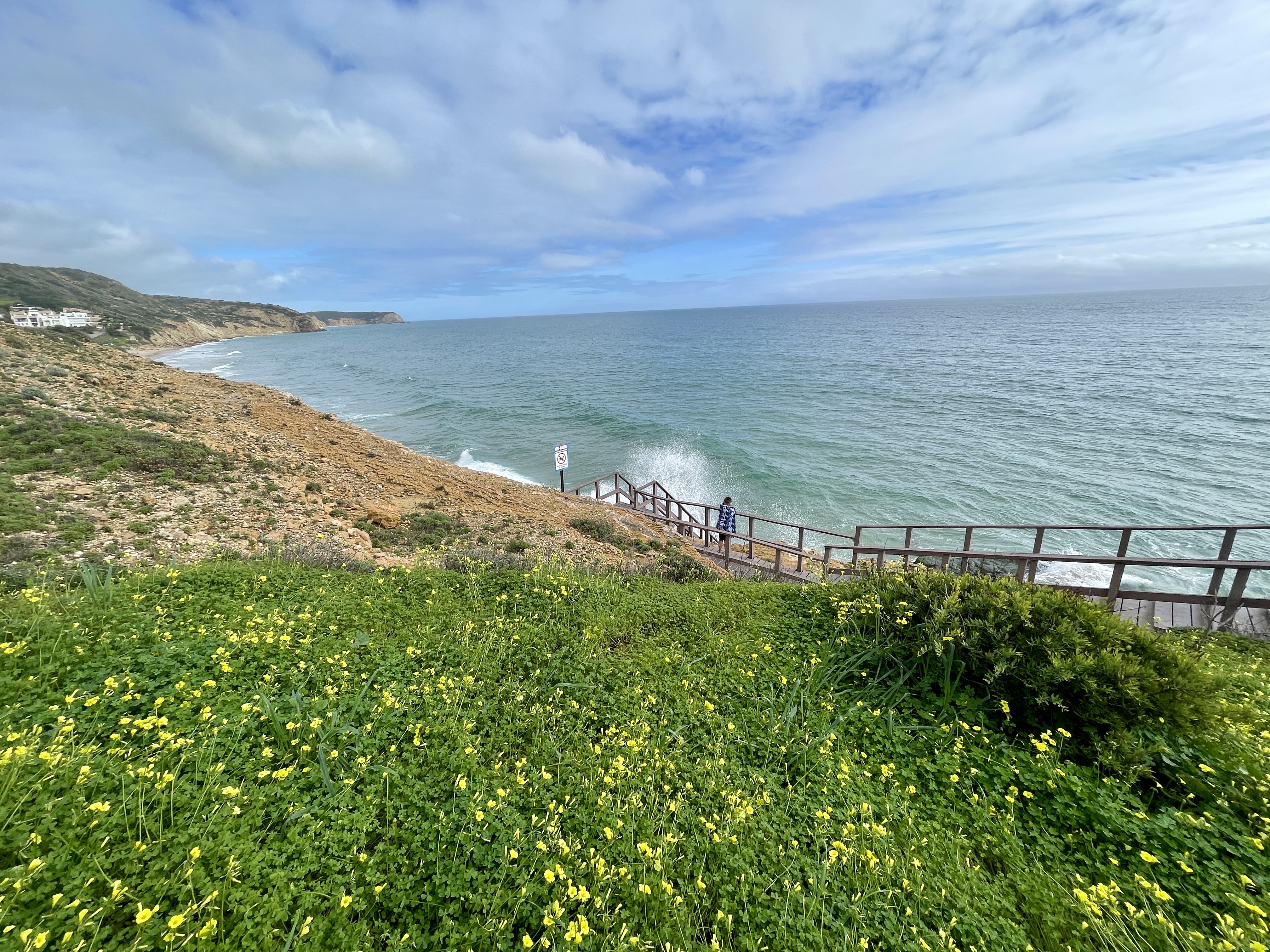 Watching waves at high tide at salema beach in Portugal