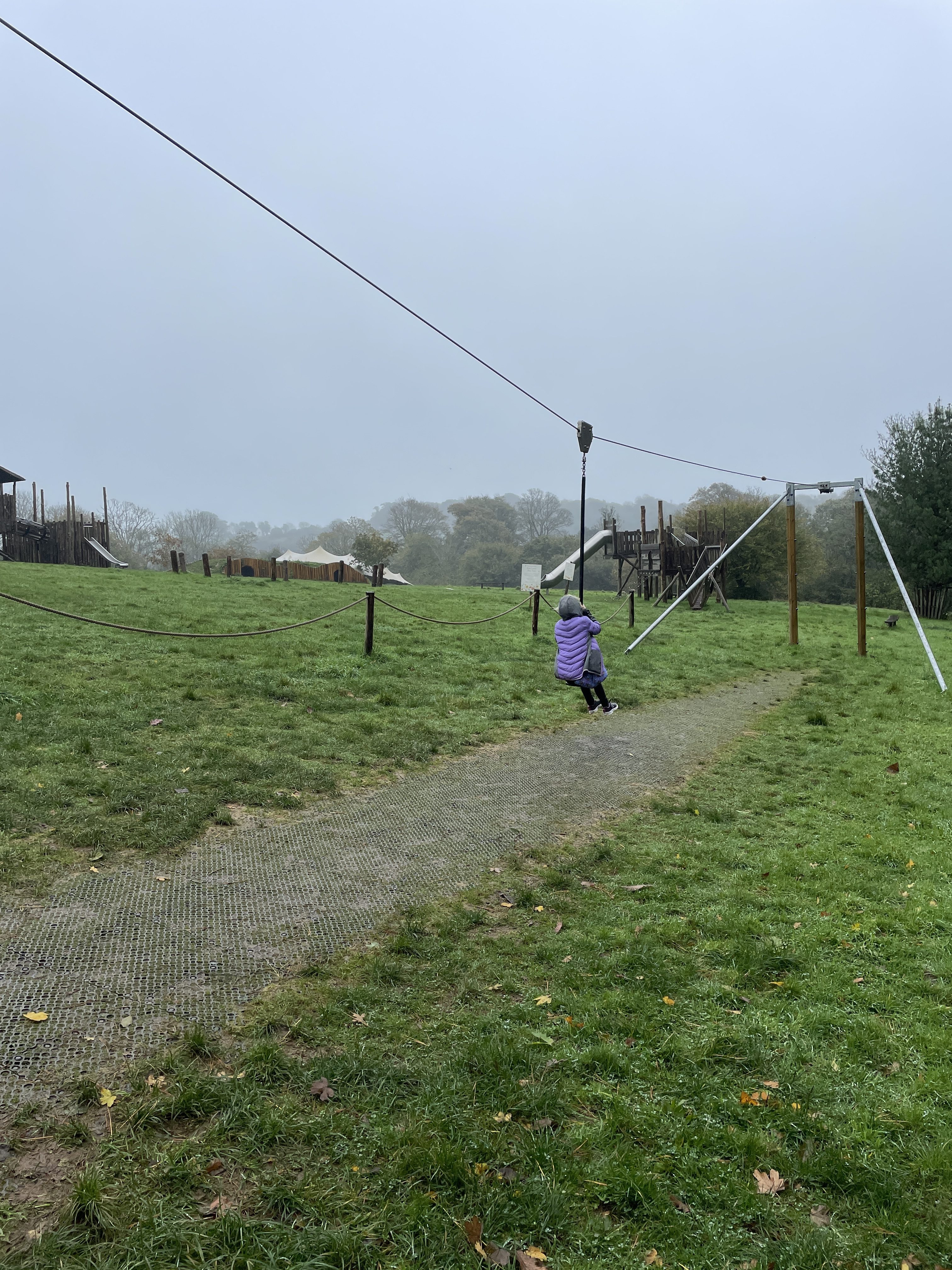 Having fun on the zipline at Heligan Play Meadow, The Lost Gardens of Heligan