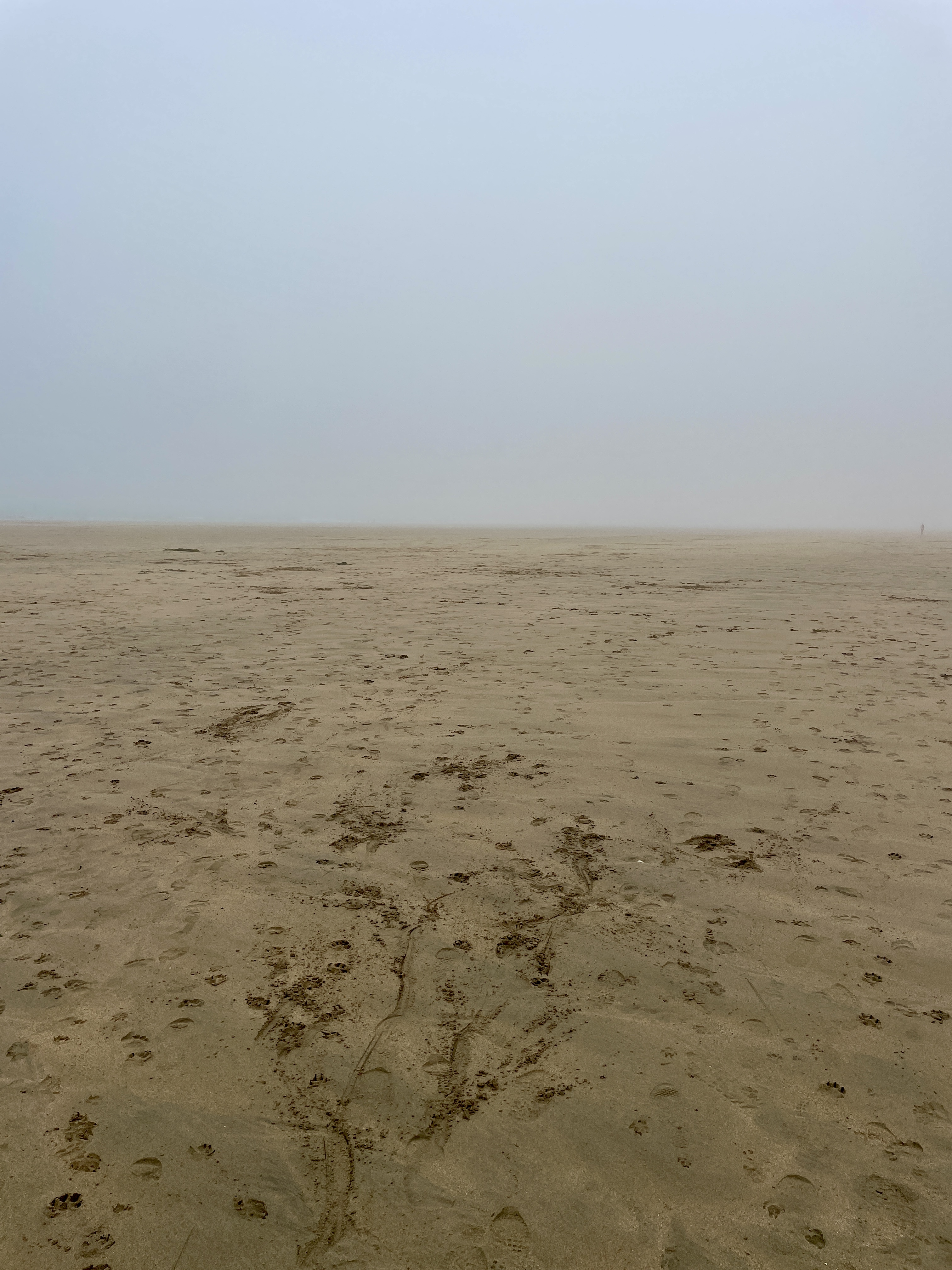 Sea mist obscures the view of the ocean at Fistral Beach