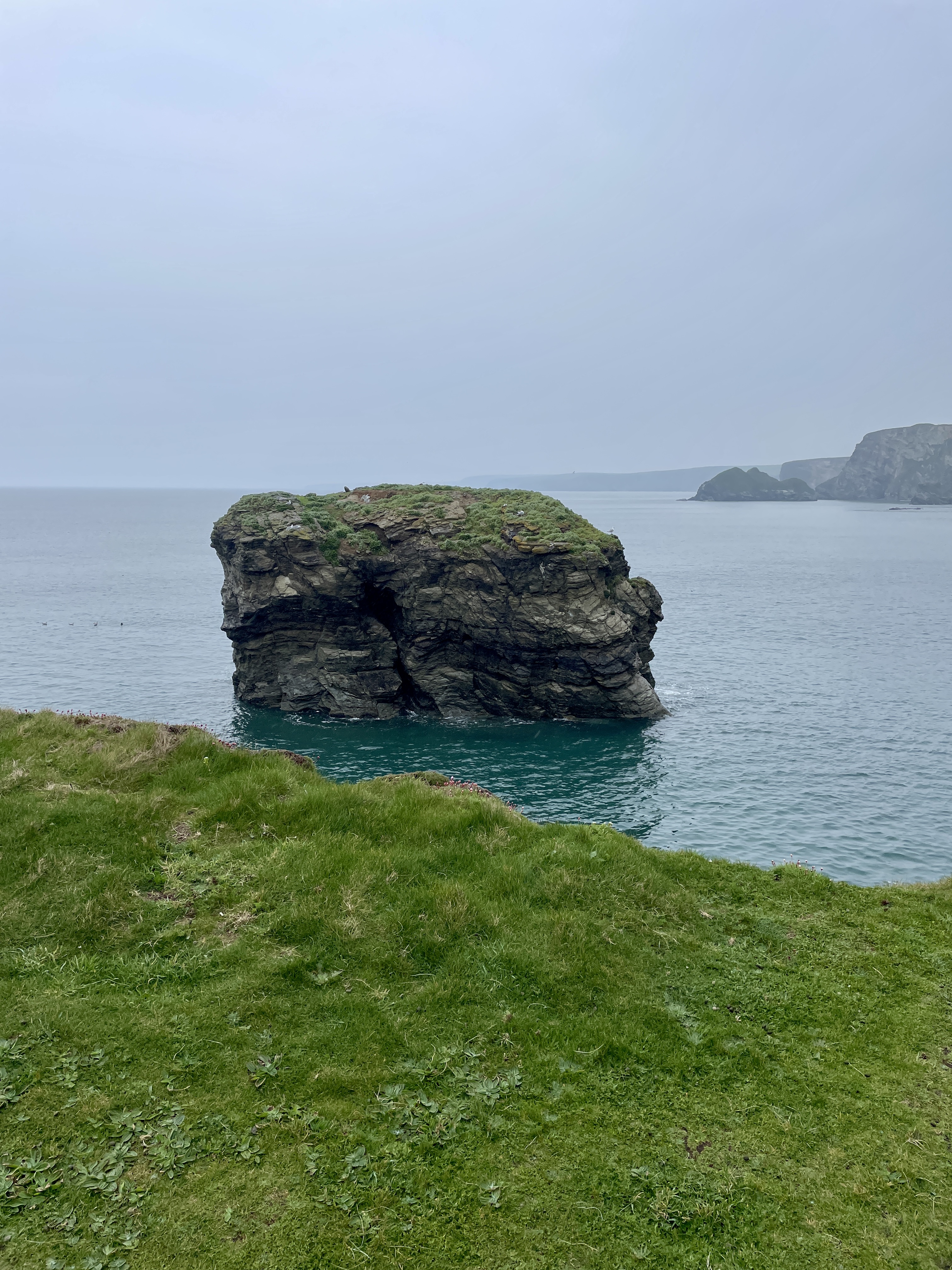 Rocky outcrop in stunning coloured sea water viewed from Porth Island. Zacry's Island in the distance.