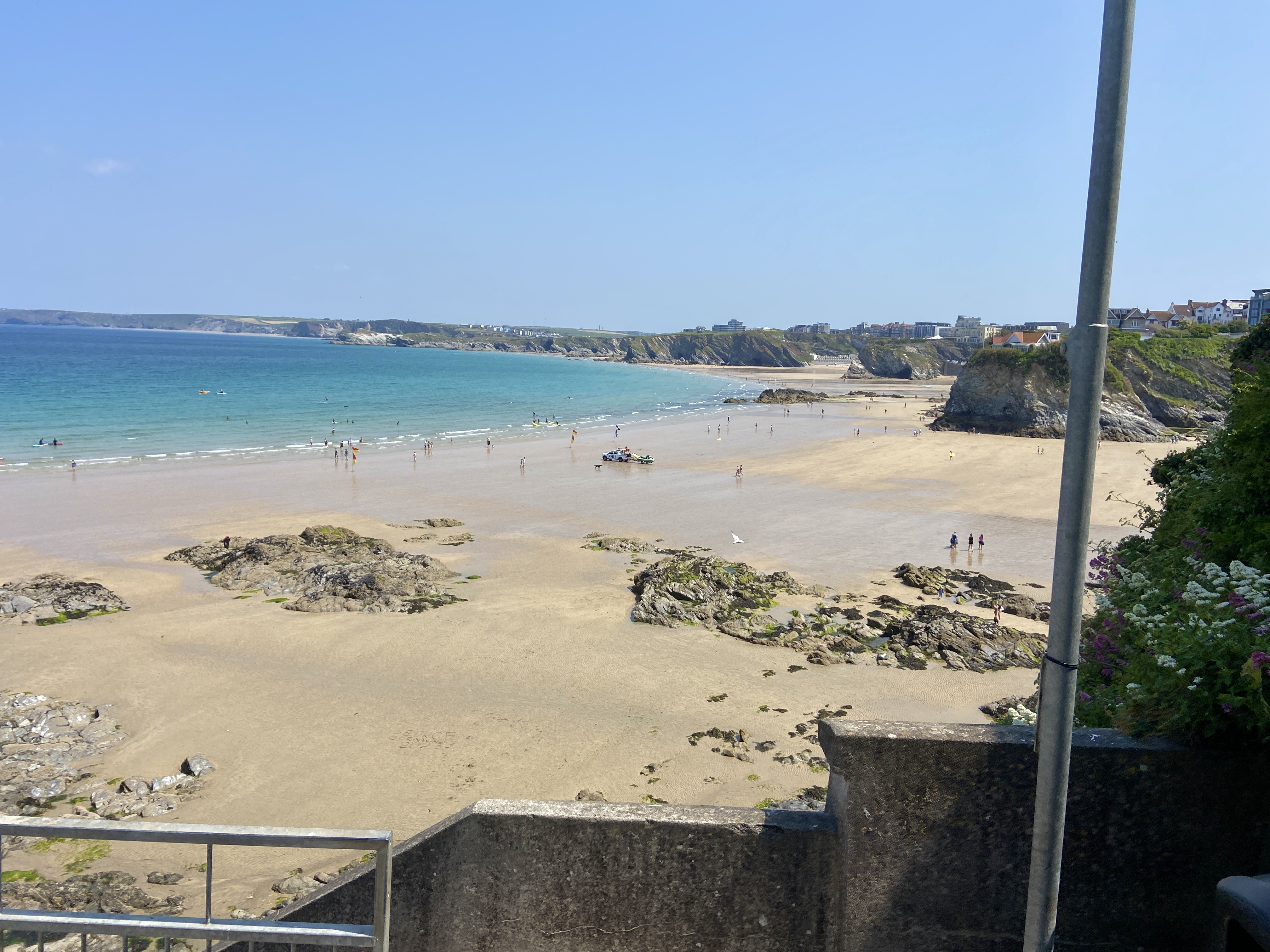 Towan Beach at low tide with Great Western and Tolcarne beaches accessible along the sand.