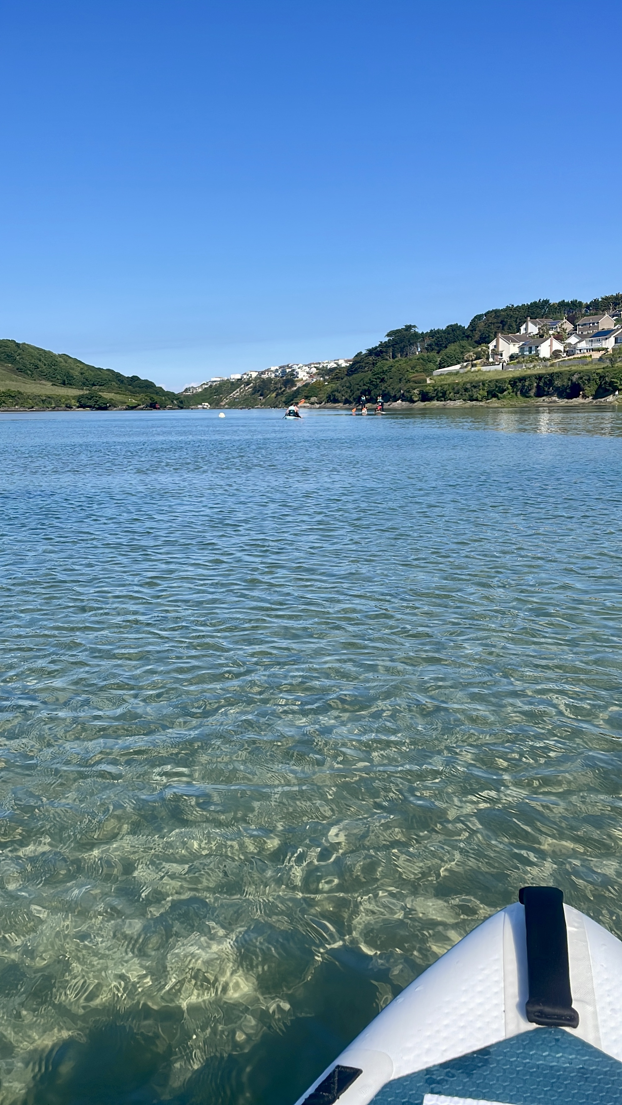 paddleboarding on the gannel river at high tide in newquay on a supyak