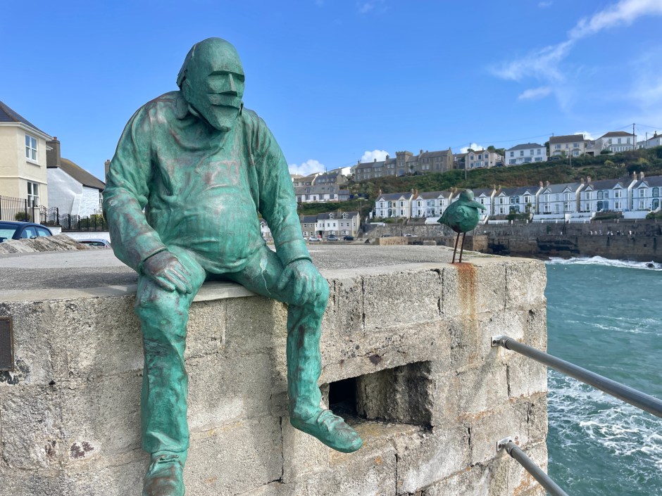 waiting for fish sculpture in bronze in porthleven cornwall