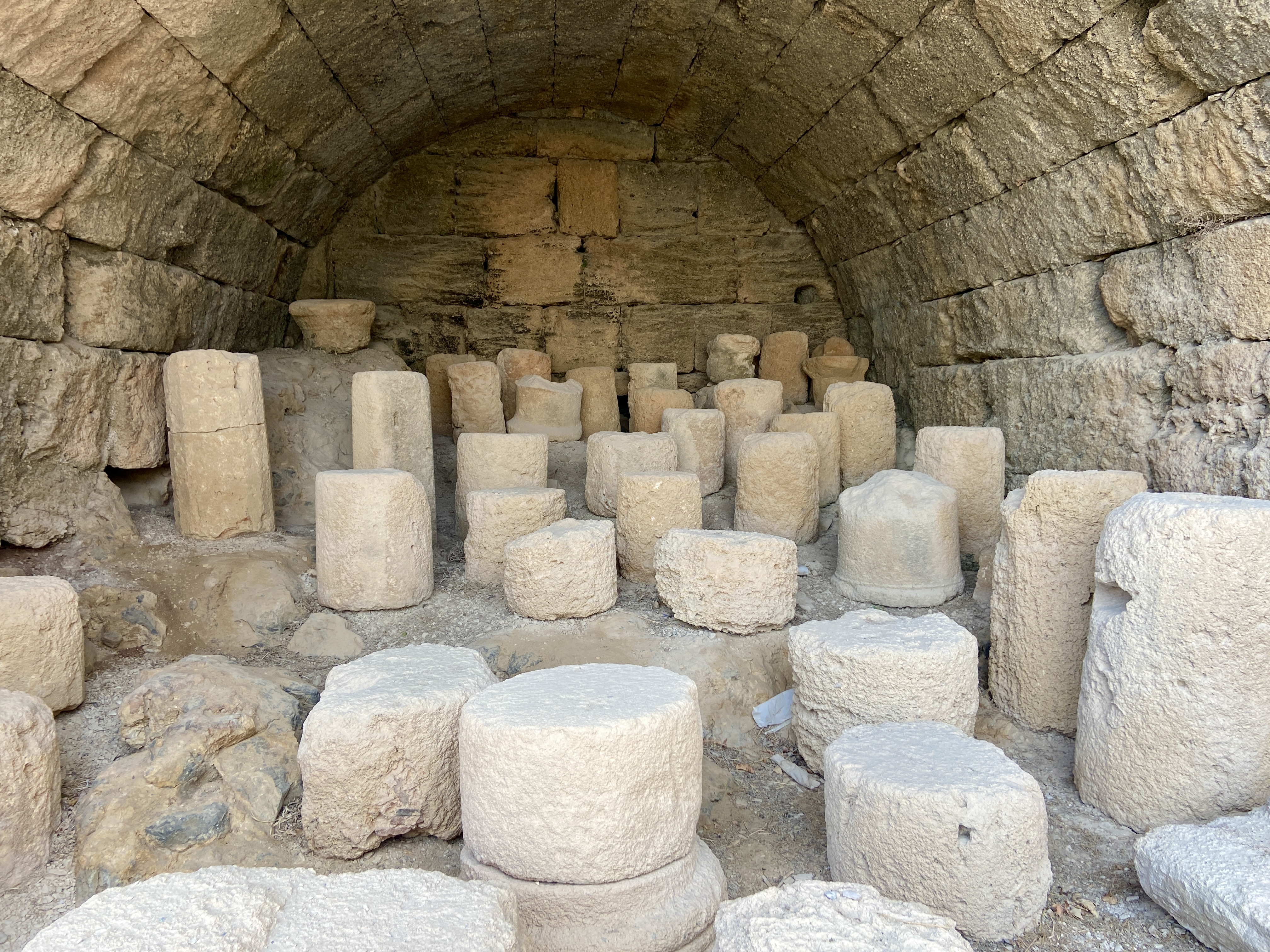 Catalogued fragments and stone blocks stored neatly for study and preservation at Lindos Acropolis.