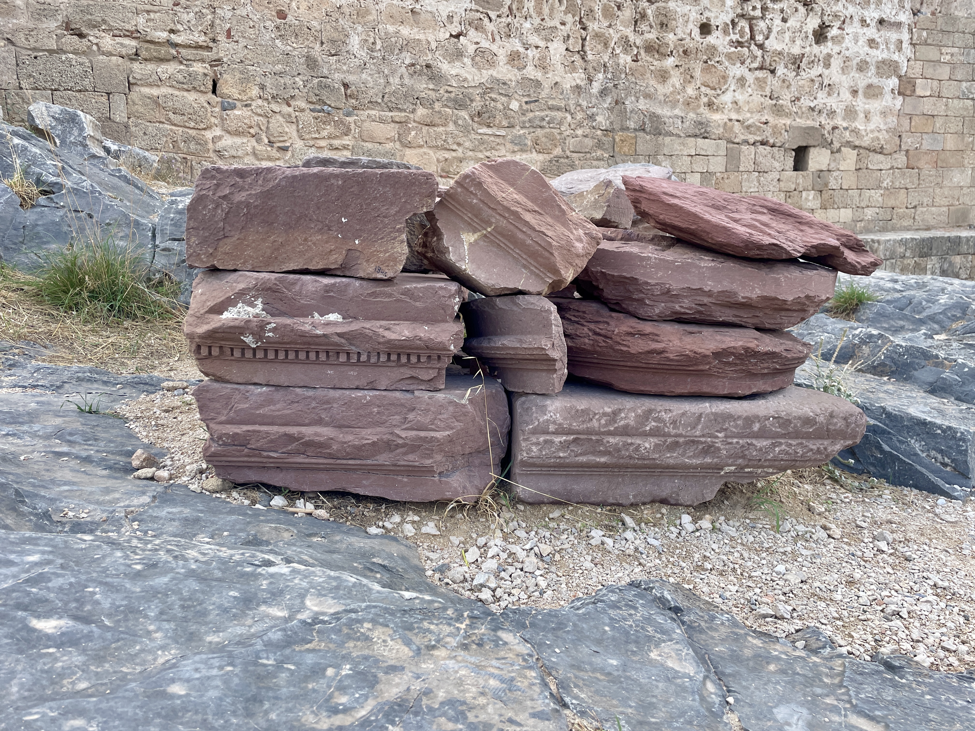 Architectural pieces stacked around the Lindos Acropolis site