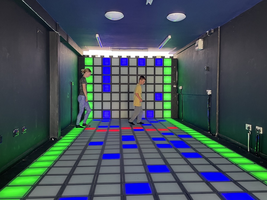 Bright pixel lights and gaming wall inside Pixel Pop