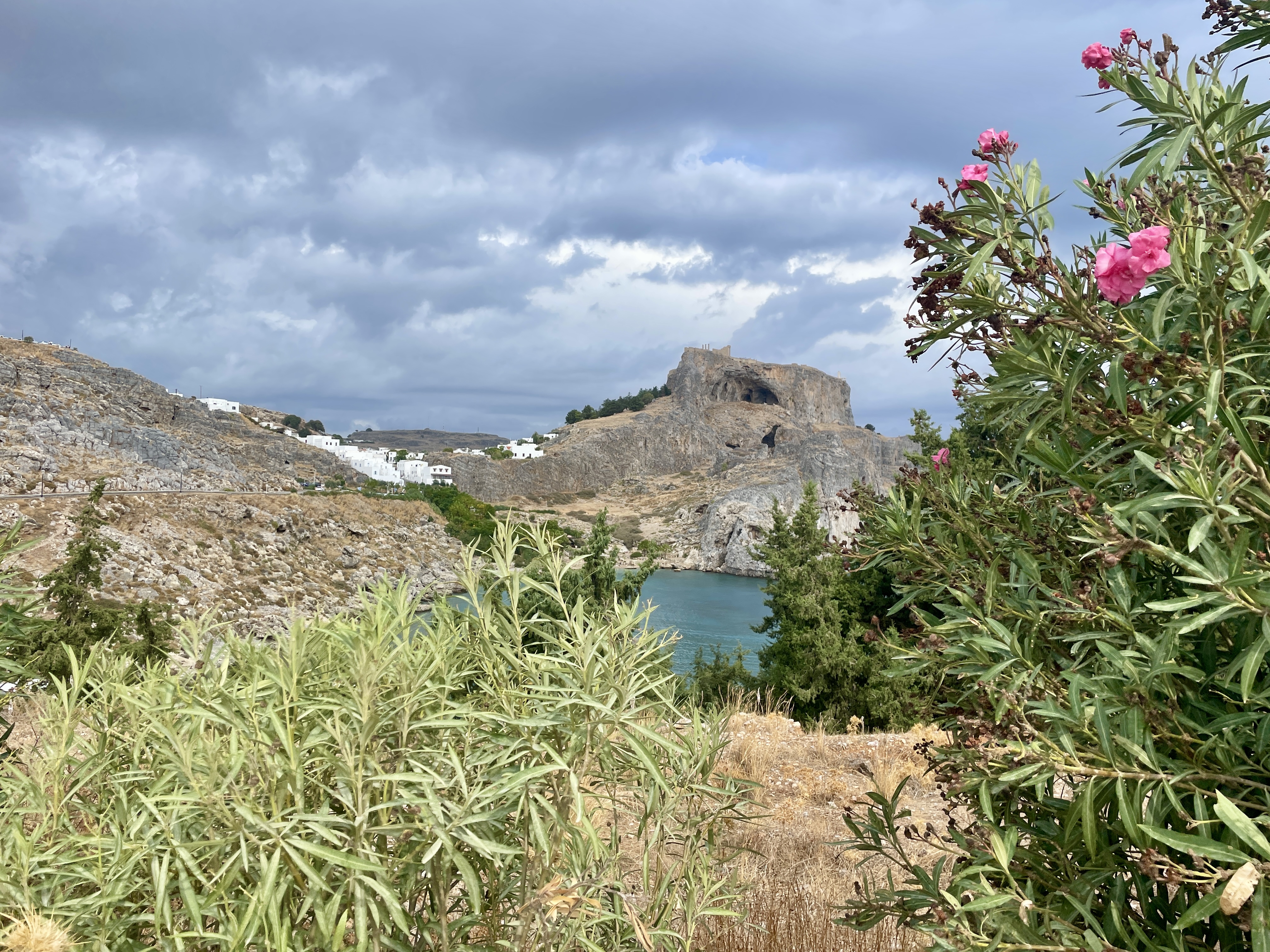 A sneak peek of St Paul's Bay waters with the whitewashed buildings of Lindos in the distance and the Acropolis up high.