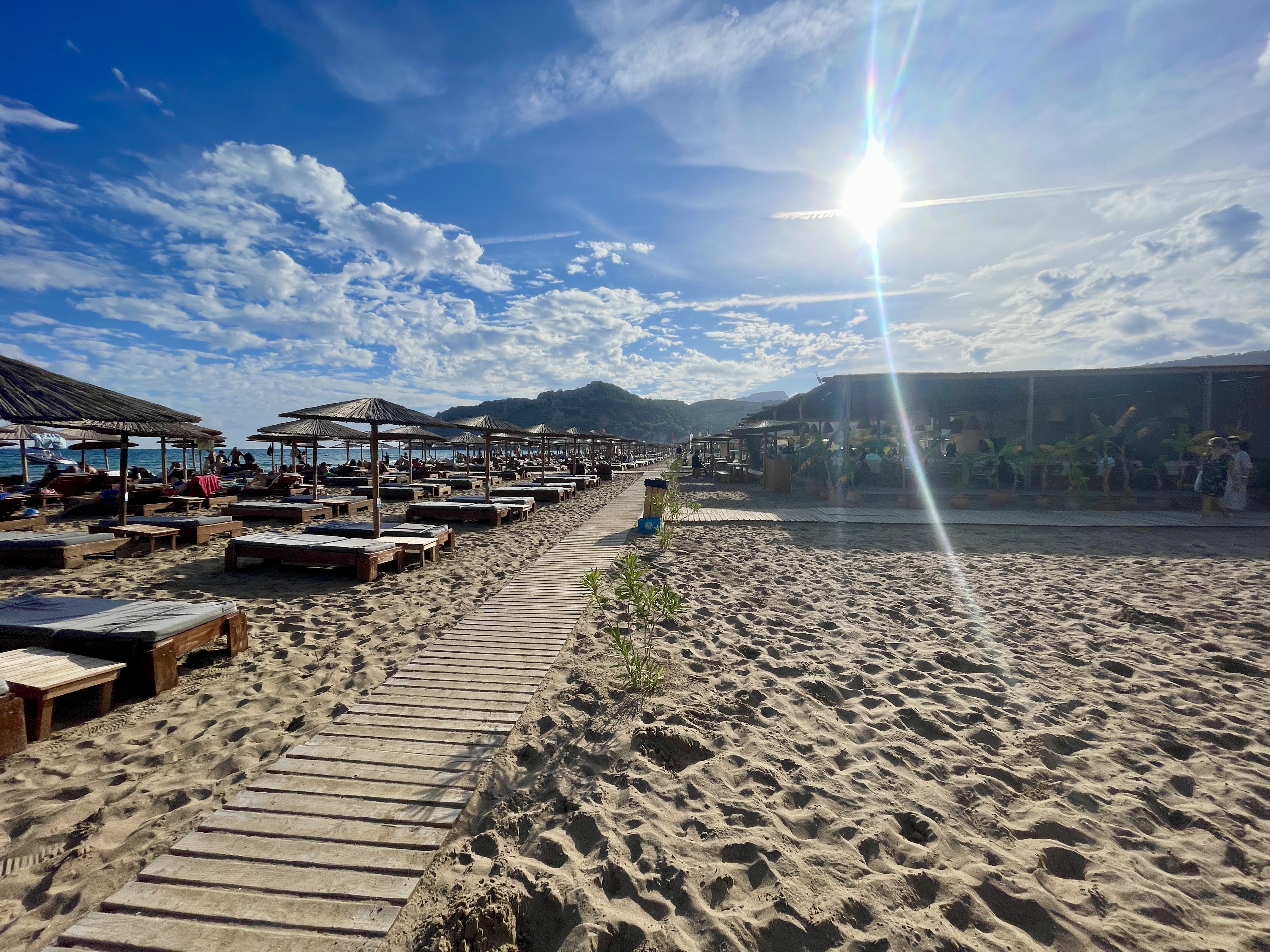 Parasols, beach bars and restaurants with a boho vibe line the beach at Tsambika in Rhodes