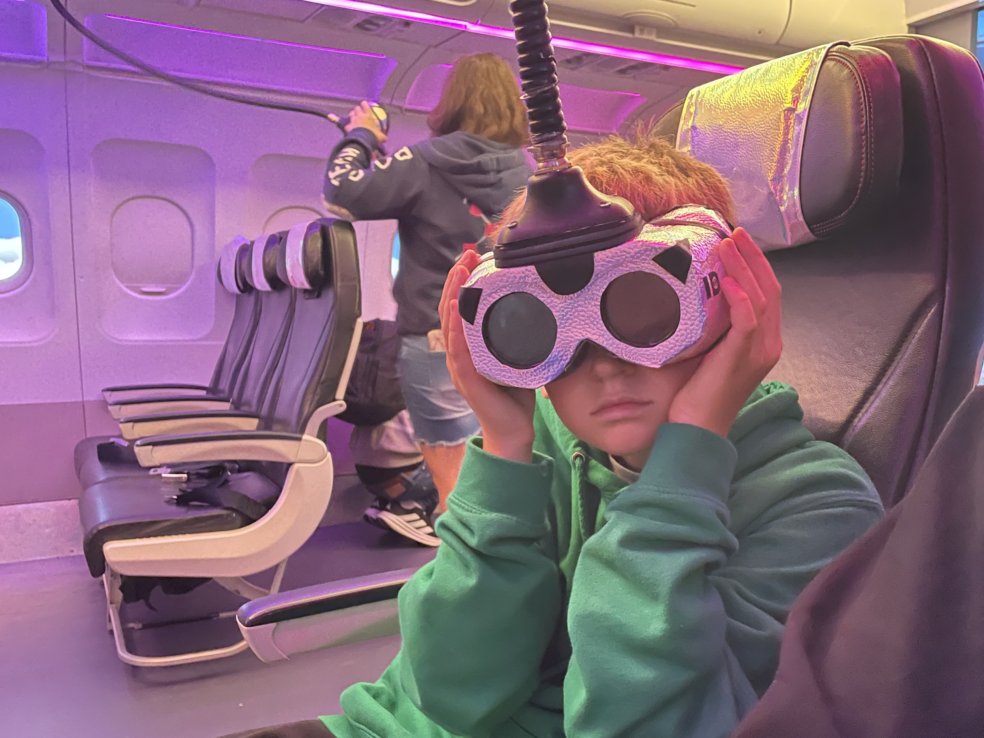 Children on the plane to the Outerverse at Wake the Tiger Bristol wearing quirky goggles