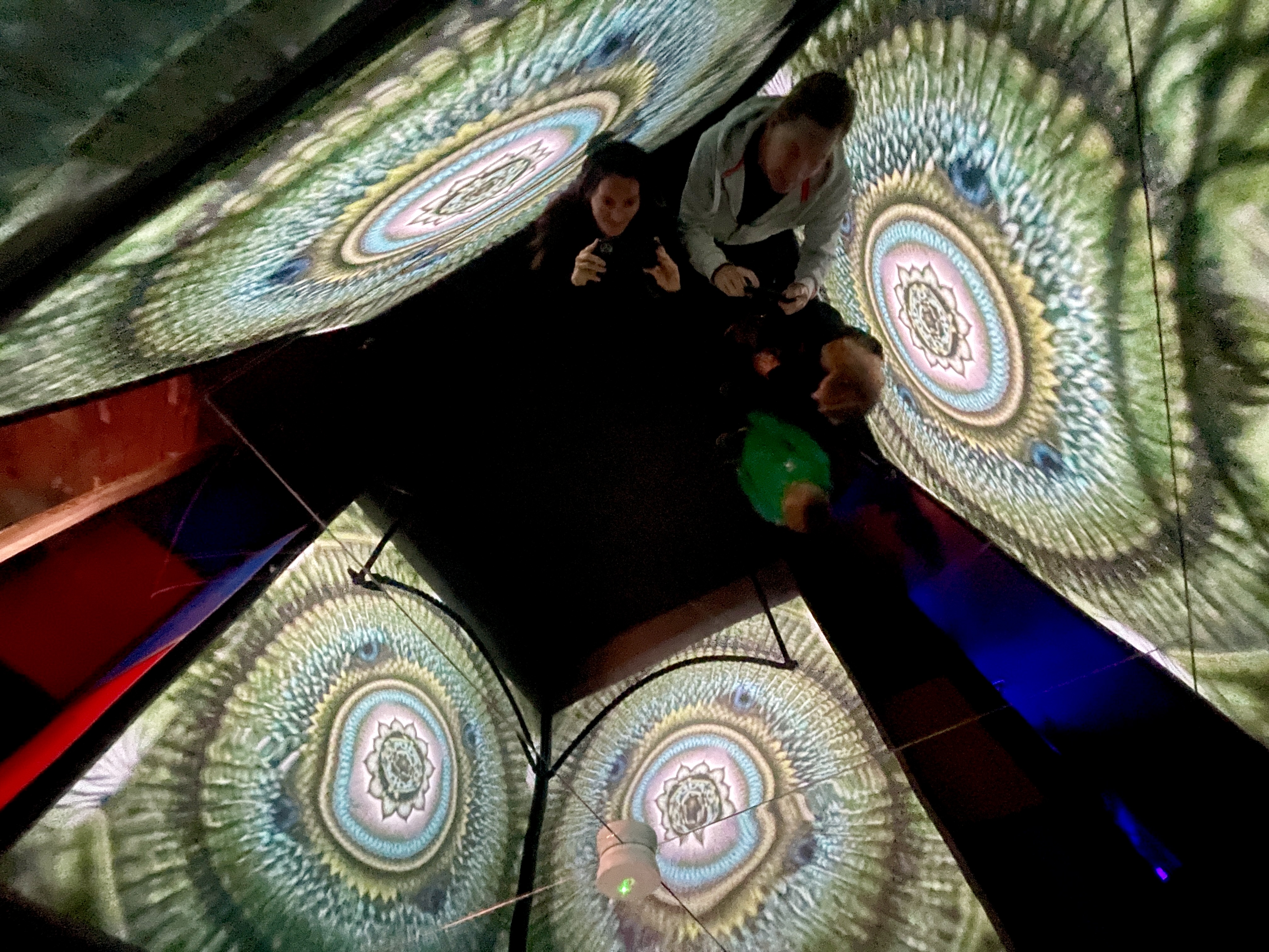 Family inside kaleidoscopic geometric projection dome at Wake the Tiger Bristol